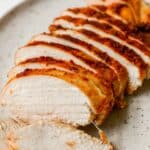 Sliced chicken breast on a plate.