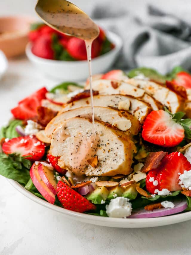 drizzling poppyseed dressing over Spinach Strawberry Salad