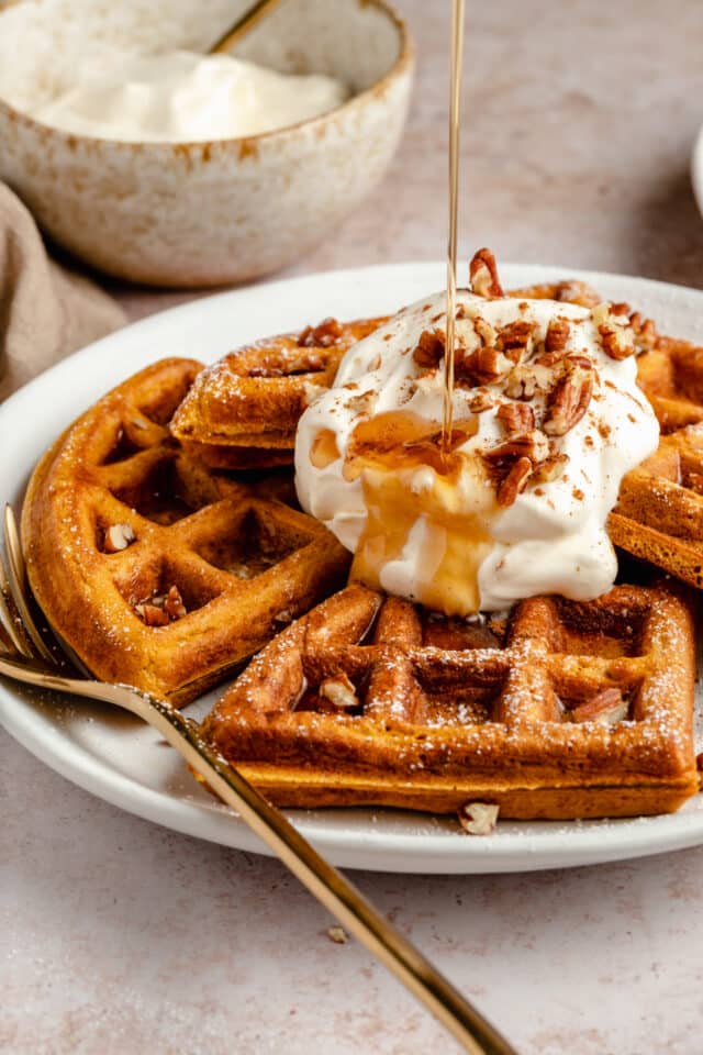 drizzling syrup over pumpkin waffles 