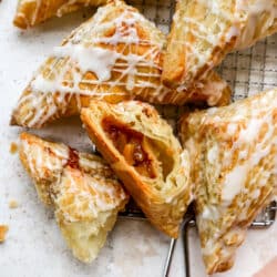 Apple turnovers drizzled with glaze.