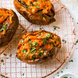 crockpot BBQ chicken stuffed in a sweet potato and topped with cheese