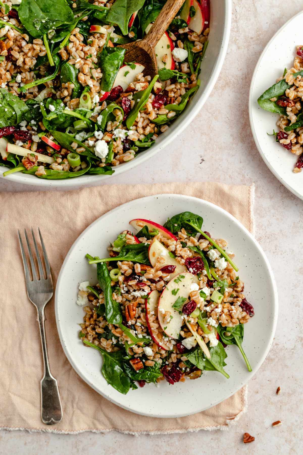 Farro salad served on small white plates.