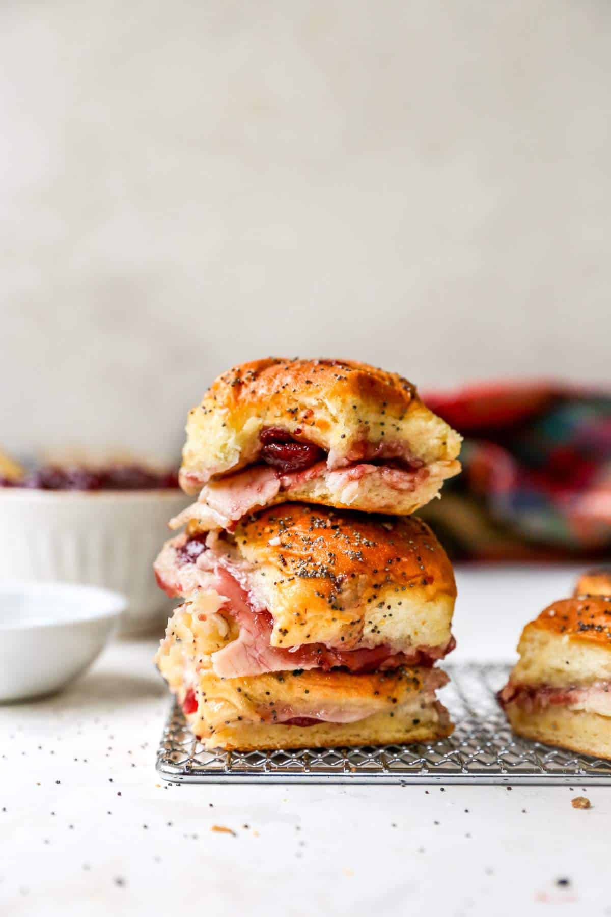 Turkey cranberry sliders stacked on a wire rack.