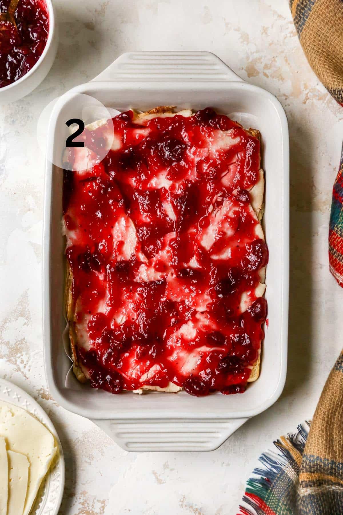 Cranberry sauce spread over sliced turkey on rolls.