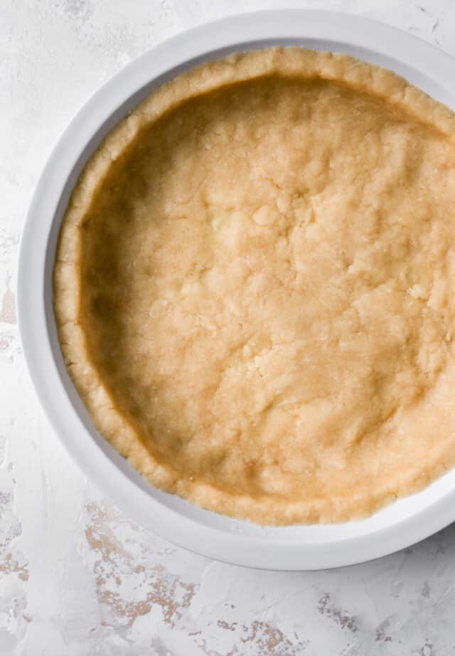 easy pie crust that has been patted in a pie dish