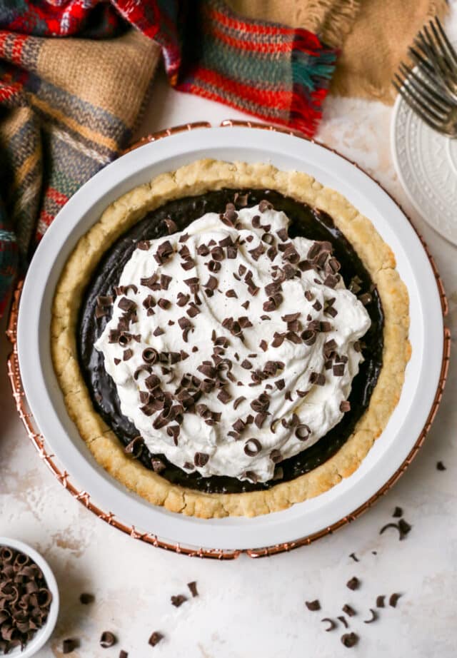 chocolate pie topped with whipped cream topping and chocolate curls