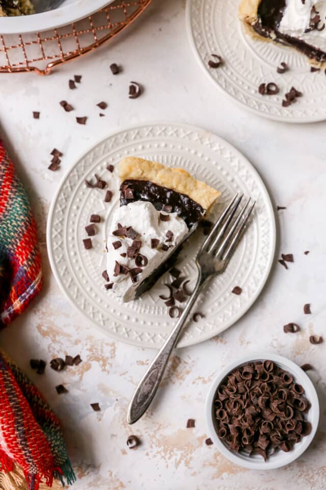 slice of chocolate pie topped with whipped cream and chocolate shavings