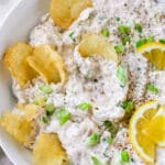 clam dip with potato chips dipped in