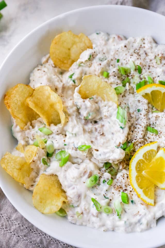 clam dip with potato chips dipped in 