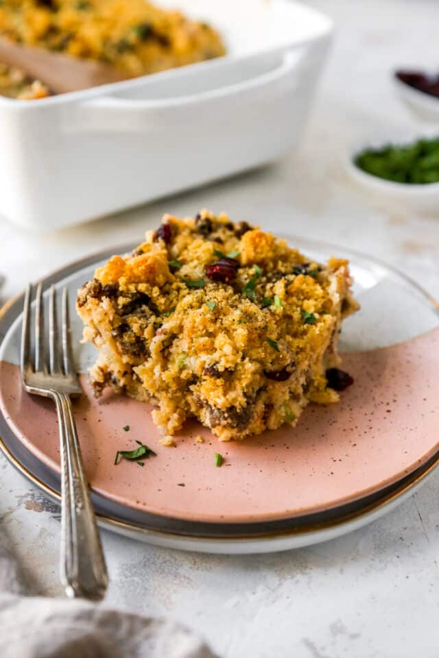 cornbread stuffing on a small plate with a fork