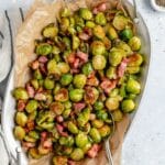 Serving bowl filled with bacon roasted Brussels sprouts.