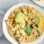 crockpot white chicken chili served in a white bowl with a spoon