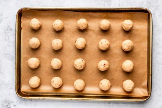 balls of cookie dough on a baking sheet