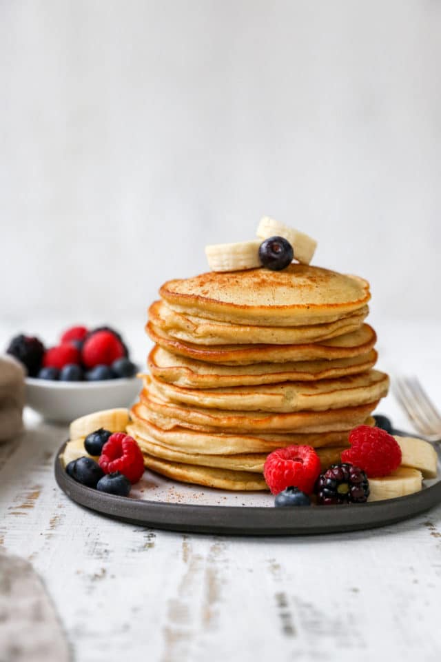 banana pancakes topped with fresh berries and banana slices