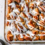 Cinnamon roll casserole topped with icing.