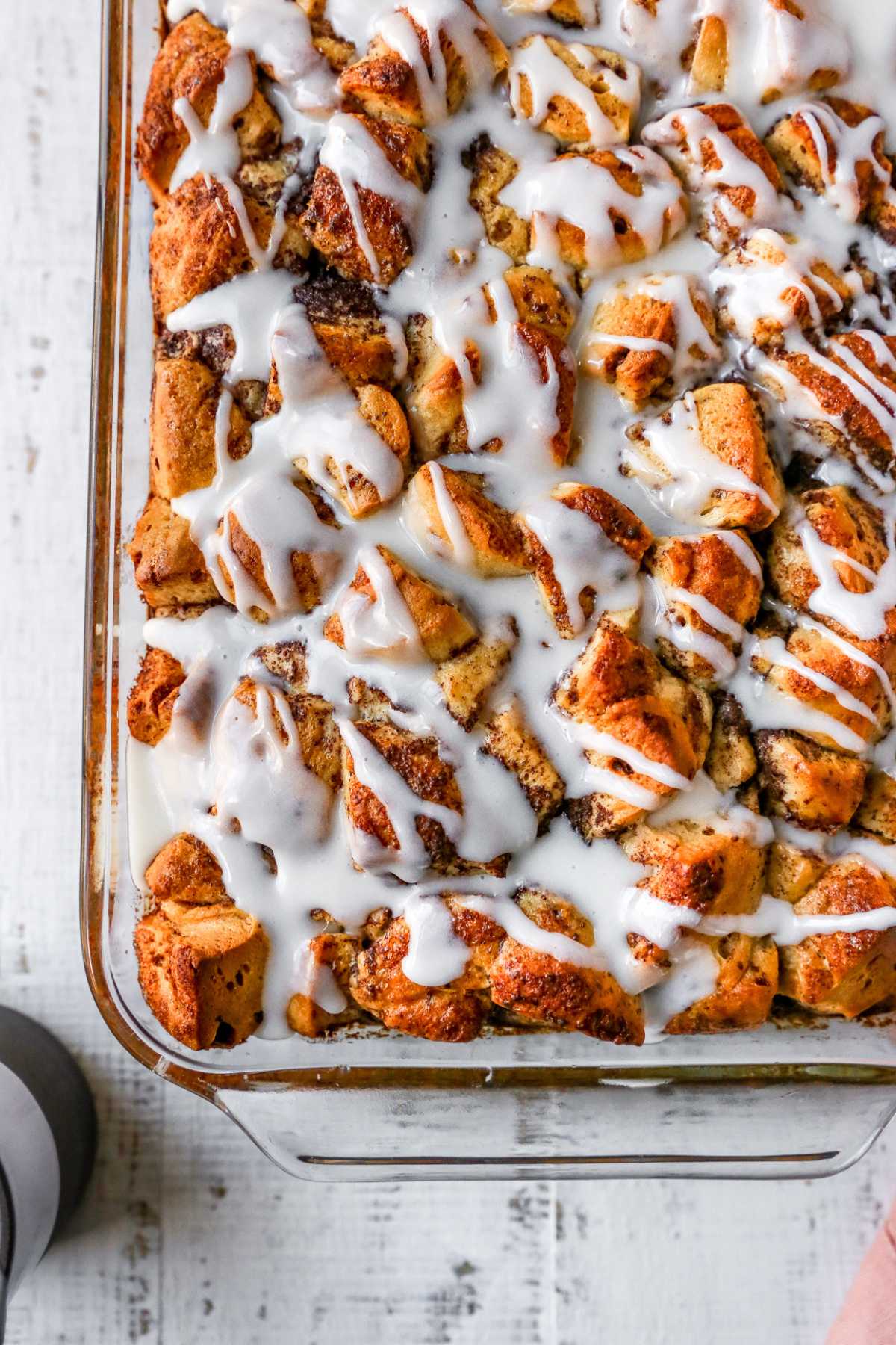 Cinnamon roll casserole topped with icing.