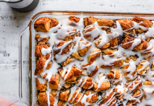 baked cinnamon roll casserole drizzled with icing