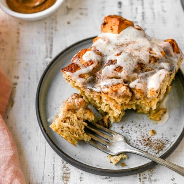 Piece of sweet breakfast casserole on a small plate with a fork.
