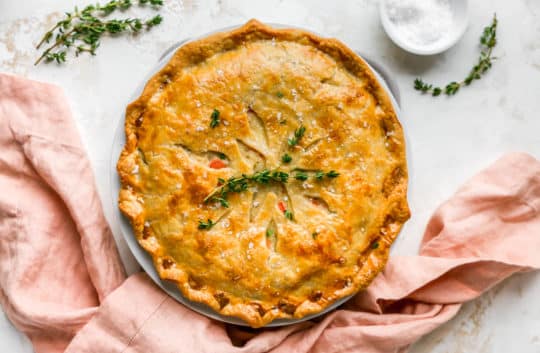 baked chicken pot pie garnished with fresh thyme