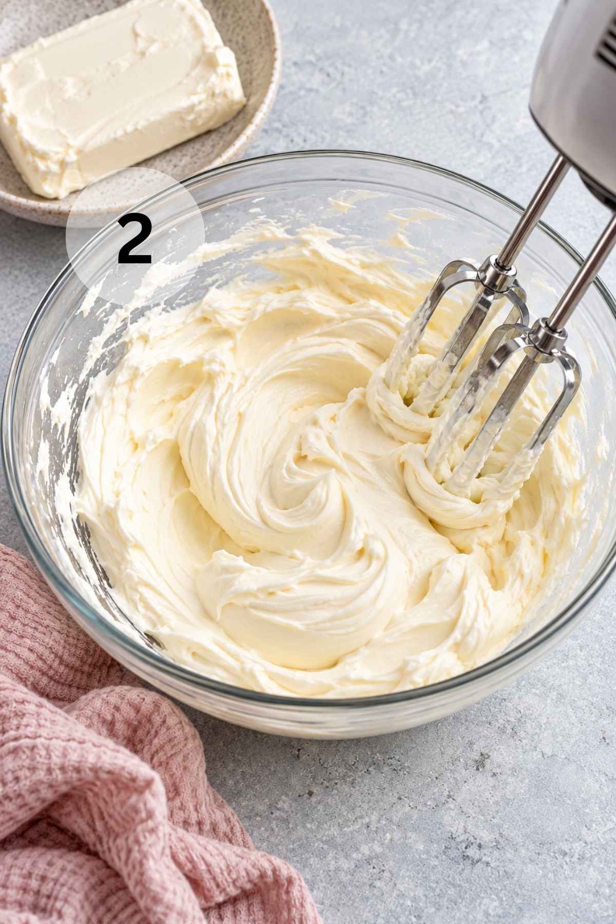 Beating cream cheese in a large bowl.