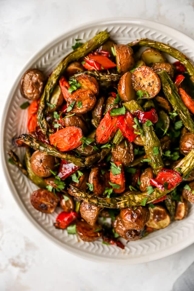 roasted vegetables in a large white serving bowl