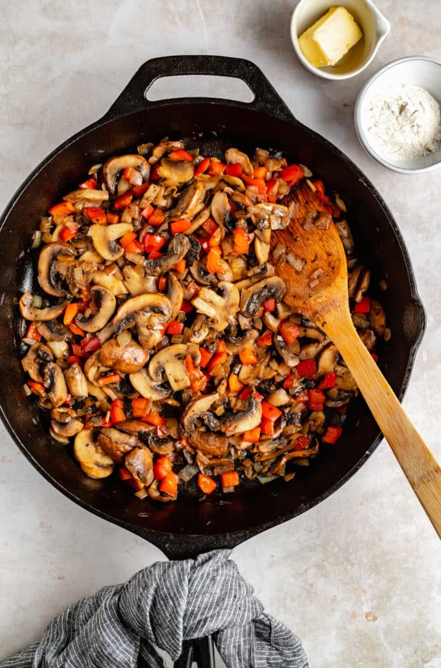 sautéing mushrooms, onion and bell pepper in a cast iron skillet