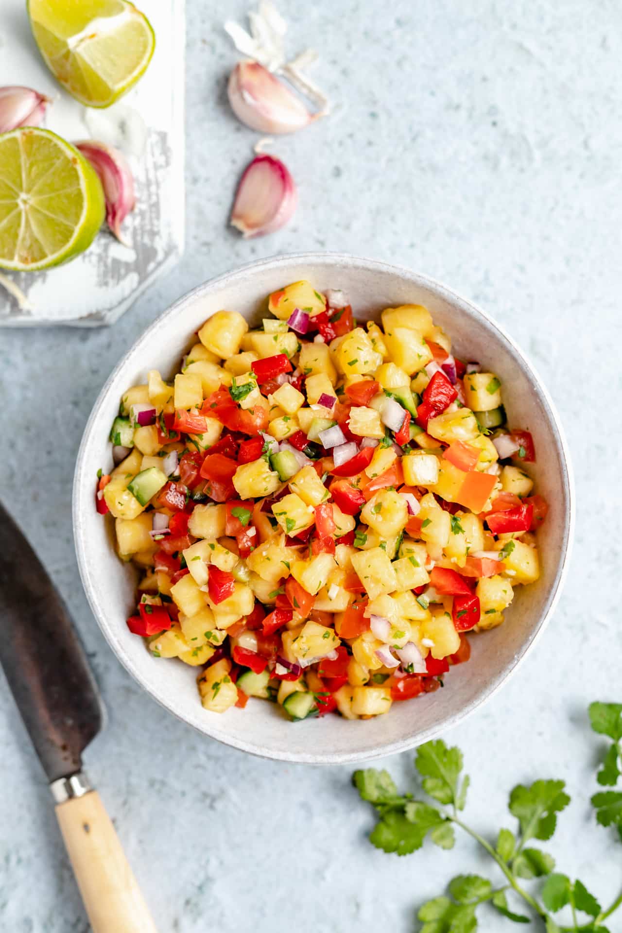 Pineapple cucumber salsa in a white bowl.