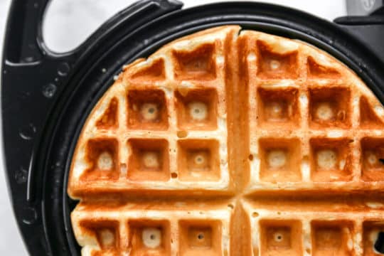 cooking a waffle on a waffle iron