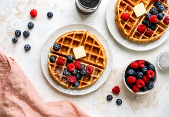 serving buttermilk waffles with butter and fresh berries