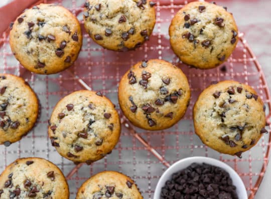 baked chocolate chip muffins on a wire cooling rack