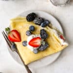 Folded crepe filled with whipped cream and fresh berries.