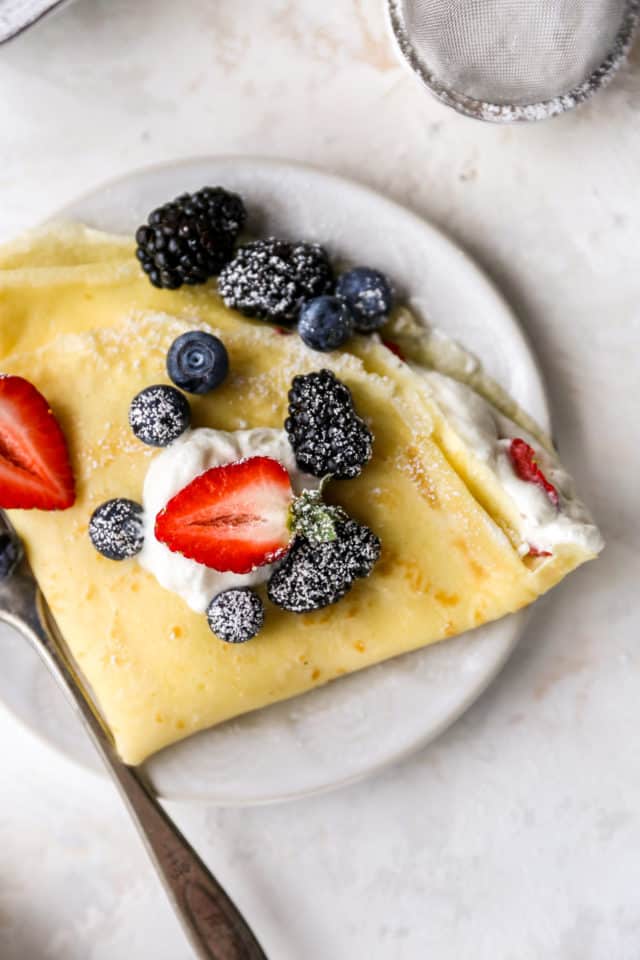 homemade crepe with berries on a plate with berries