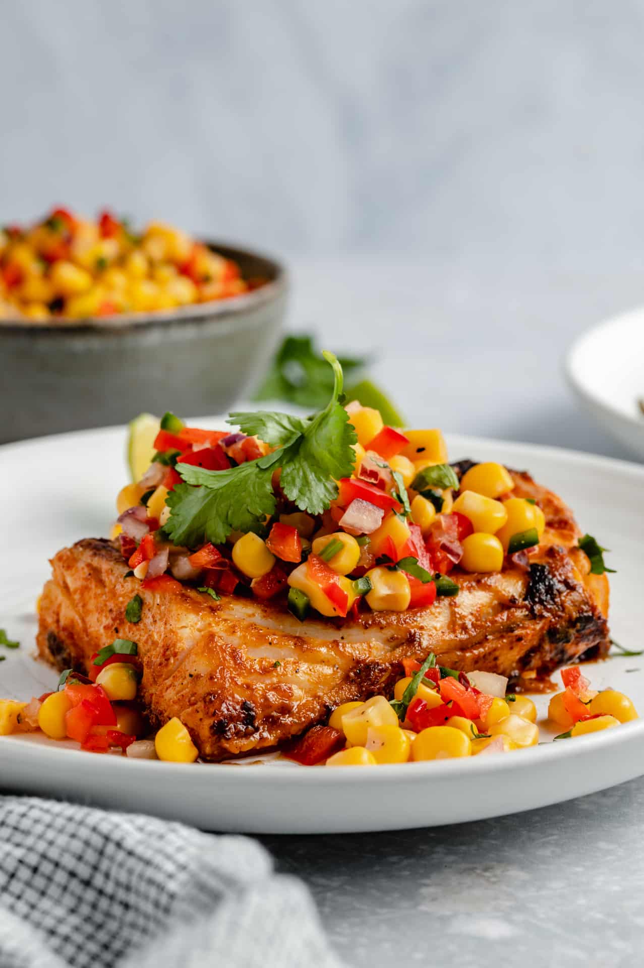 White fish served with corn salsa and fresh cilantro.
