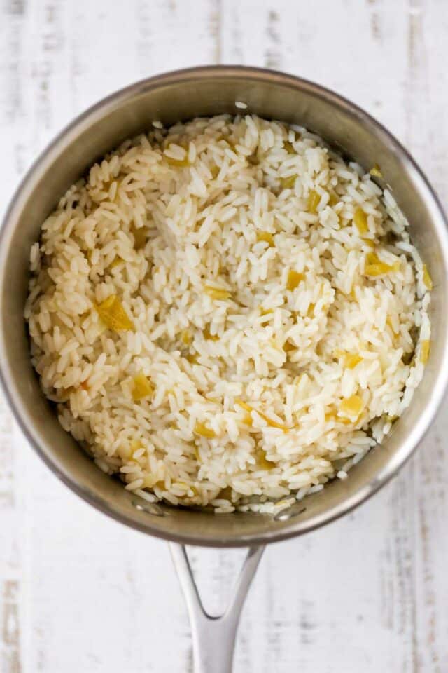 White rice mixed with green chilies in a medium saucepan.