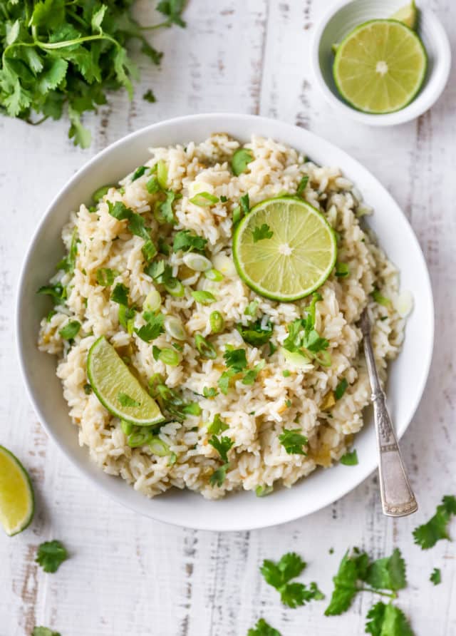 bowl filled with rice topped with cilantro and lime