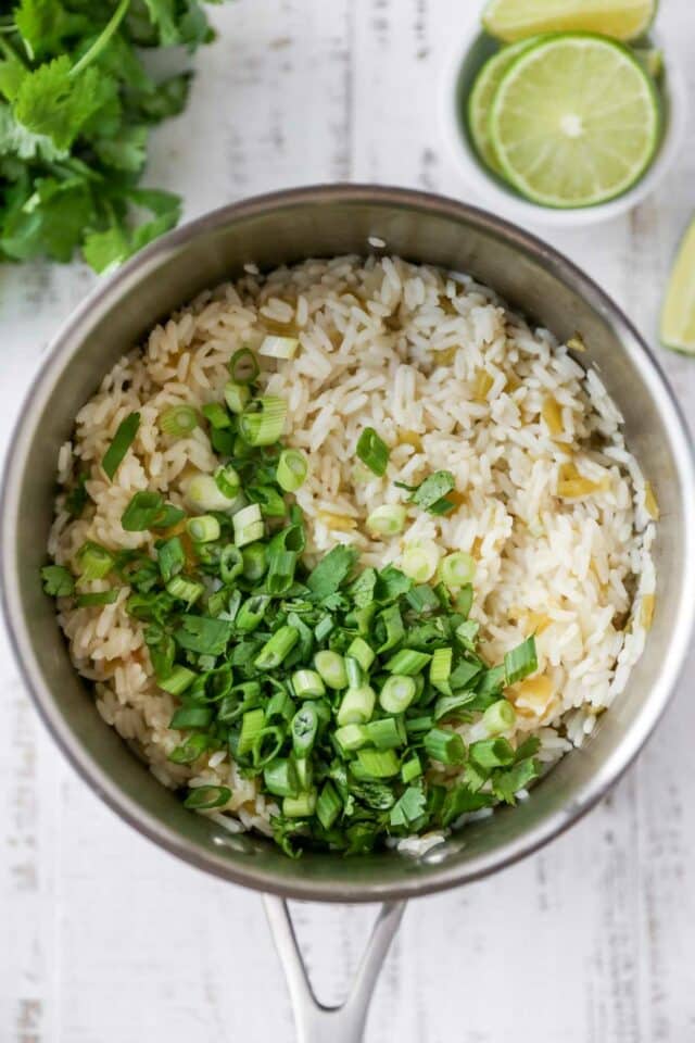 Chopped green onions over white rice.