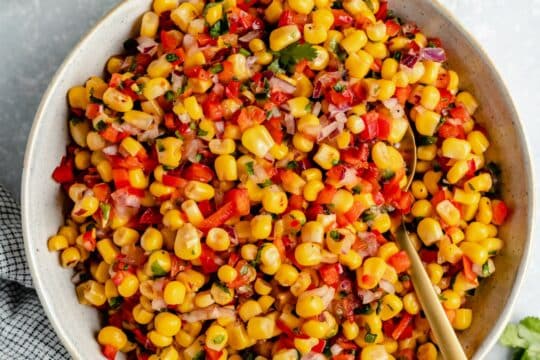 Corn salsa mixed in a white serving bowl.