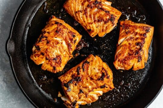 Cooking fish in a cast iron skillet.