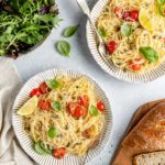 lemon pasta topped with cherry tomatoes and fresh basil