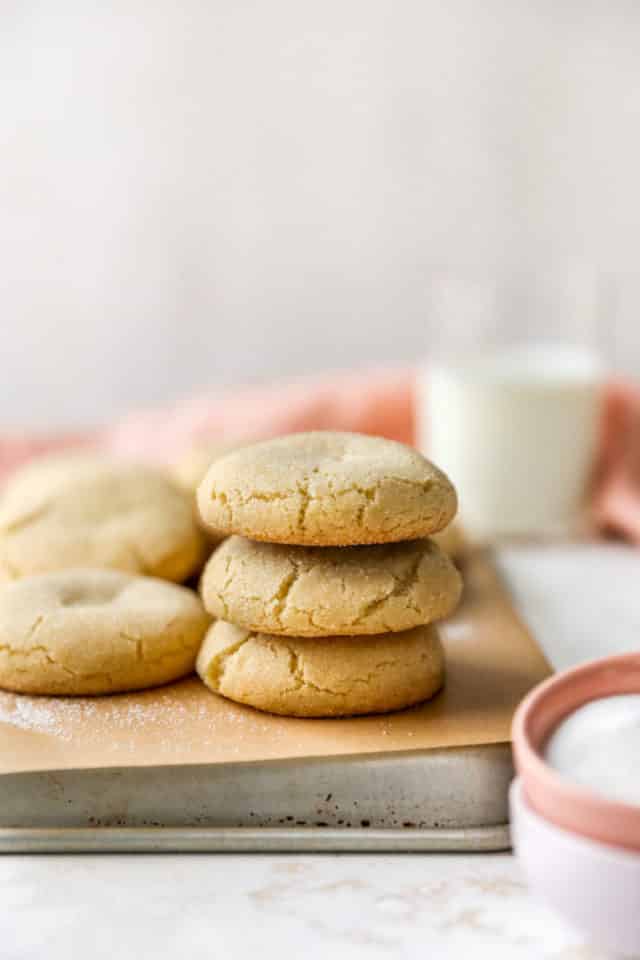 stacked sugar cookies on a baking pan