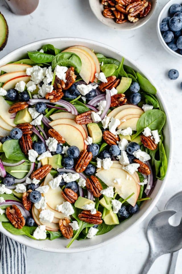 spinach salad with feta, fruit, nuts and avocado