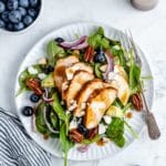spinach salad topped with chicken