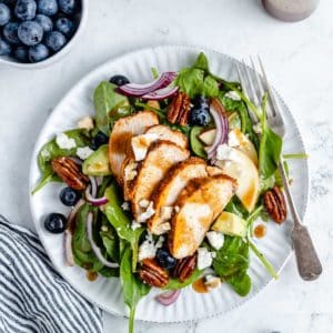 spinach salad topped with chicken