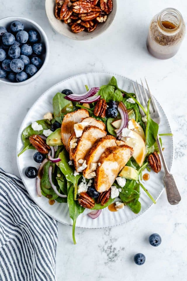 spinach salad topped with chicken 