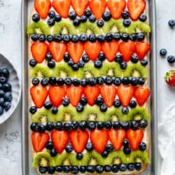 Fruit pizza on a cookie crust topped with strawberries, blueberries and kiwi.