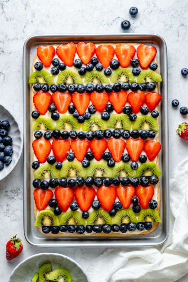 fruit pizza on a cookie crust topped with strawberries, blueberries and kiwi