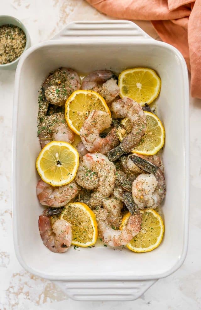 combining shrimp with lemon slices, butter and Italian seasoning in a dish