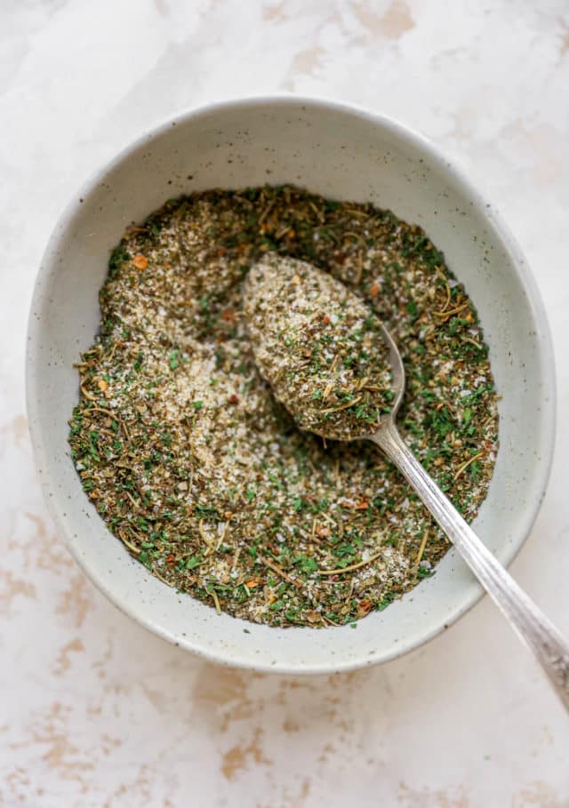 Homemade seasoning blend in a small bowl with a spoon in it.