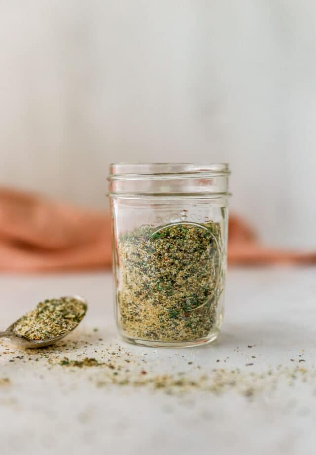 small glass jar filled with homemade seasoning blend