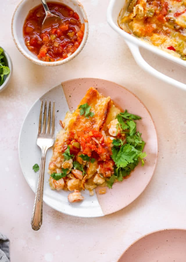 shrimp enchiladas served with salsa and fresh cilantro